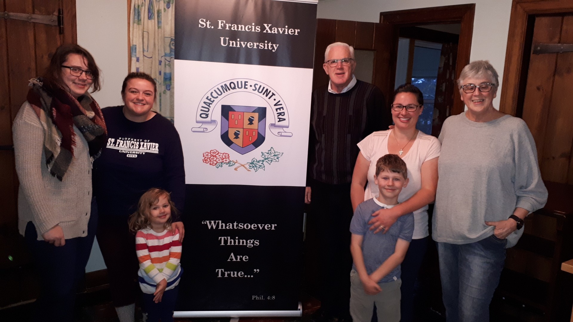 People standing with a university banner