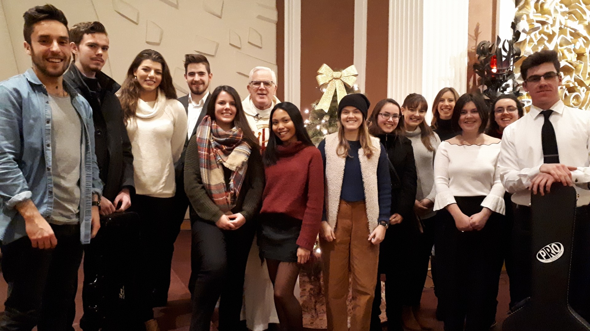 A group of people in a church standing and smiling