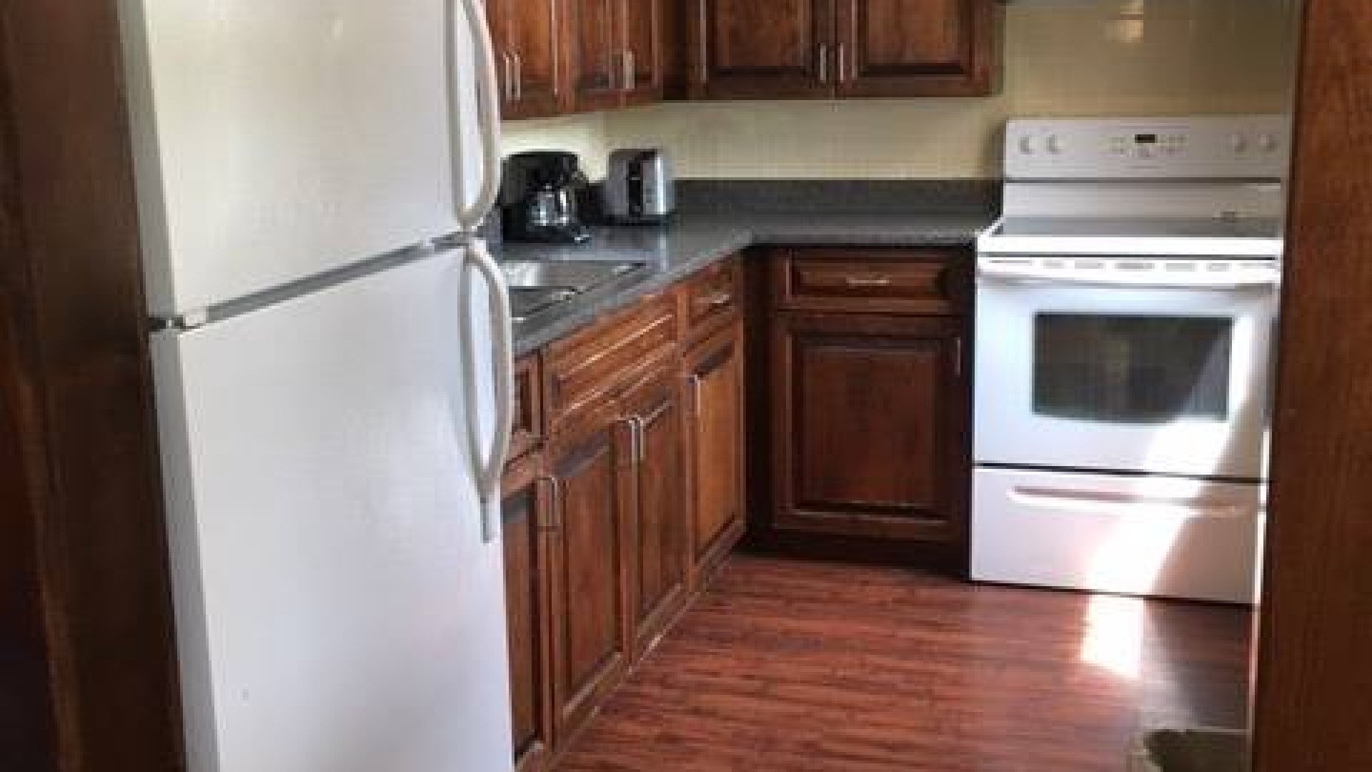 Kitchen with a fridge, oven and counter space
