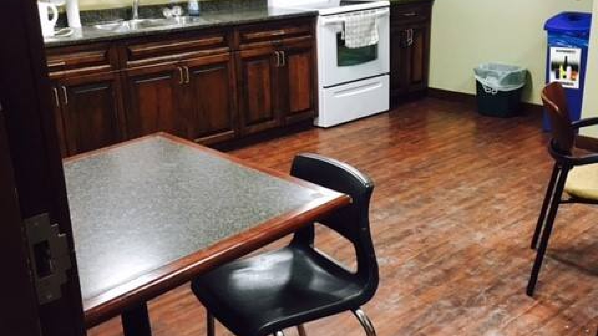 Kitchen with a fridge, oven and seating area