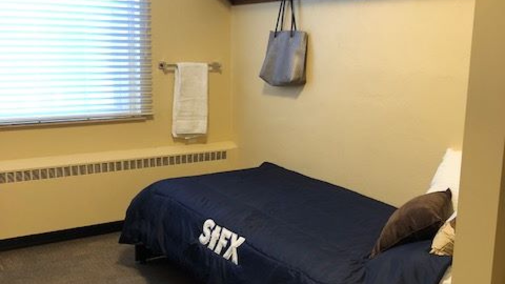 Twin size bed with shelf above for storage 