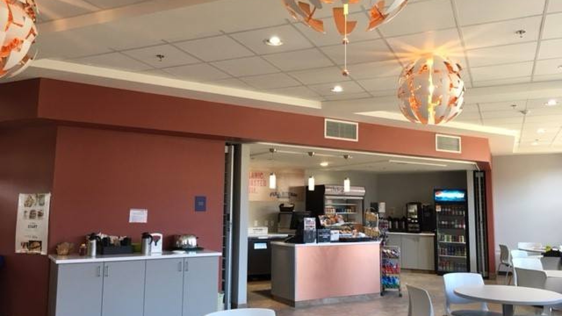 Cafe with tables and the kitchen in the background 