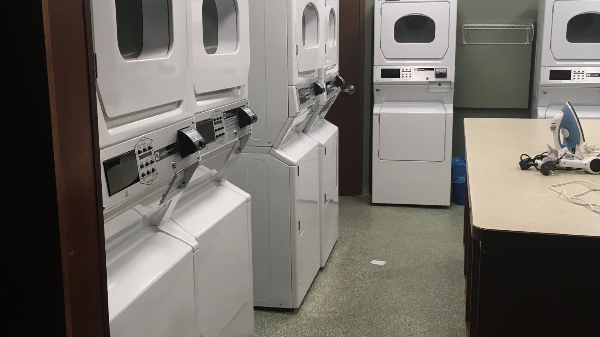Laundry room with washers and dryers lined up 