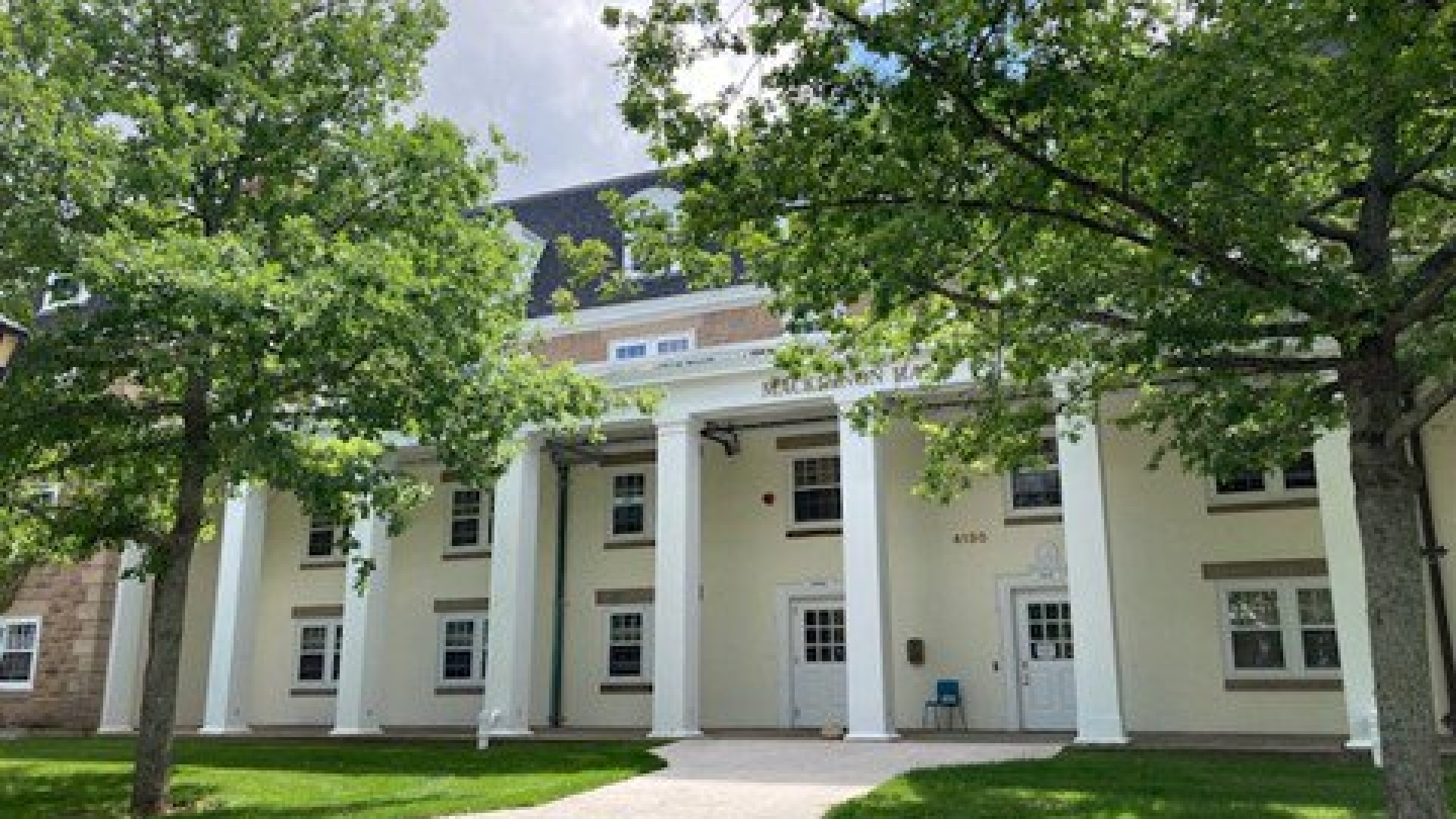 Exterior of MacKinnon Hall entrance on a sunny day 