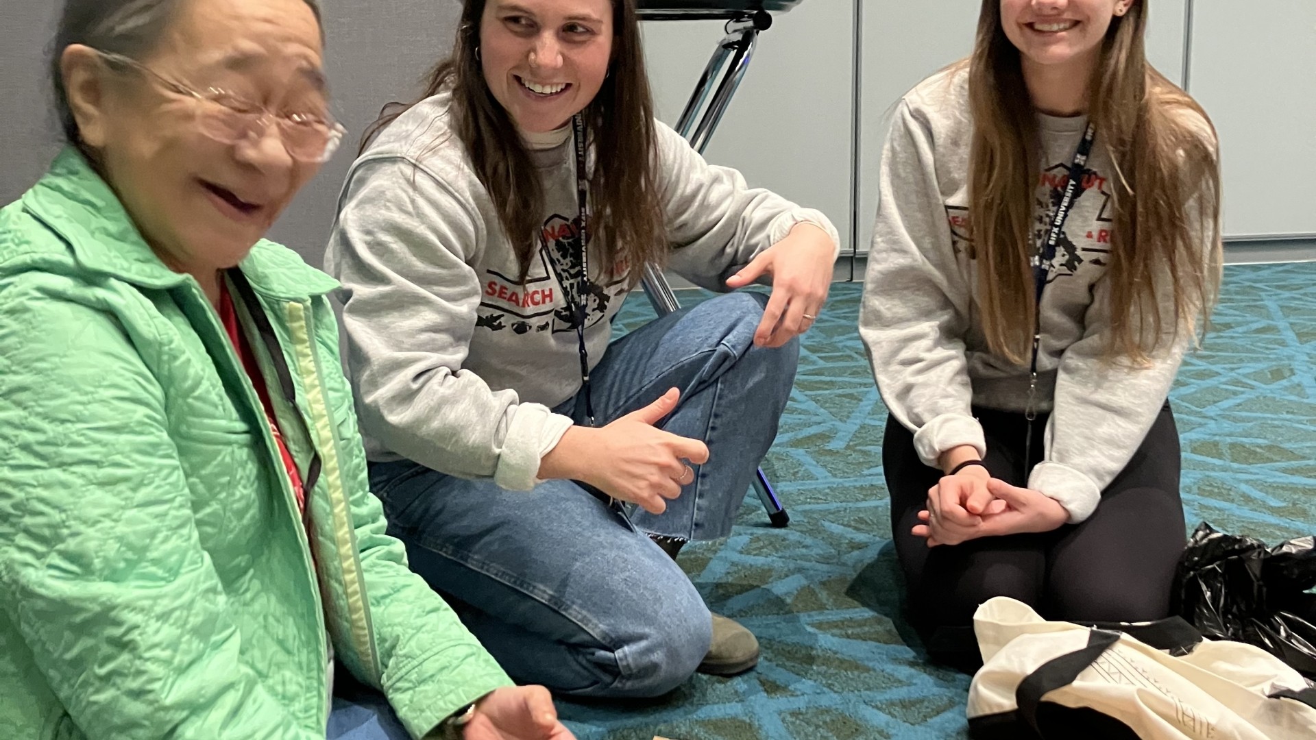 Two young women and an elder sharing food