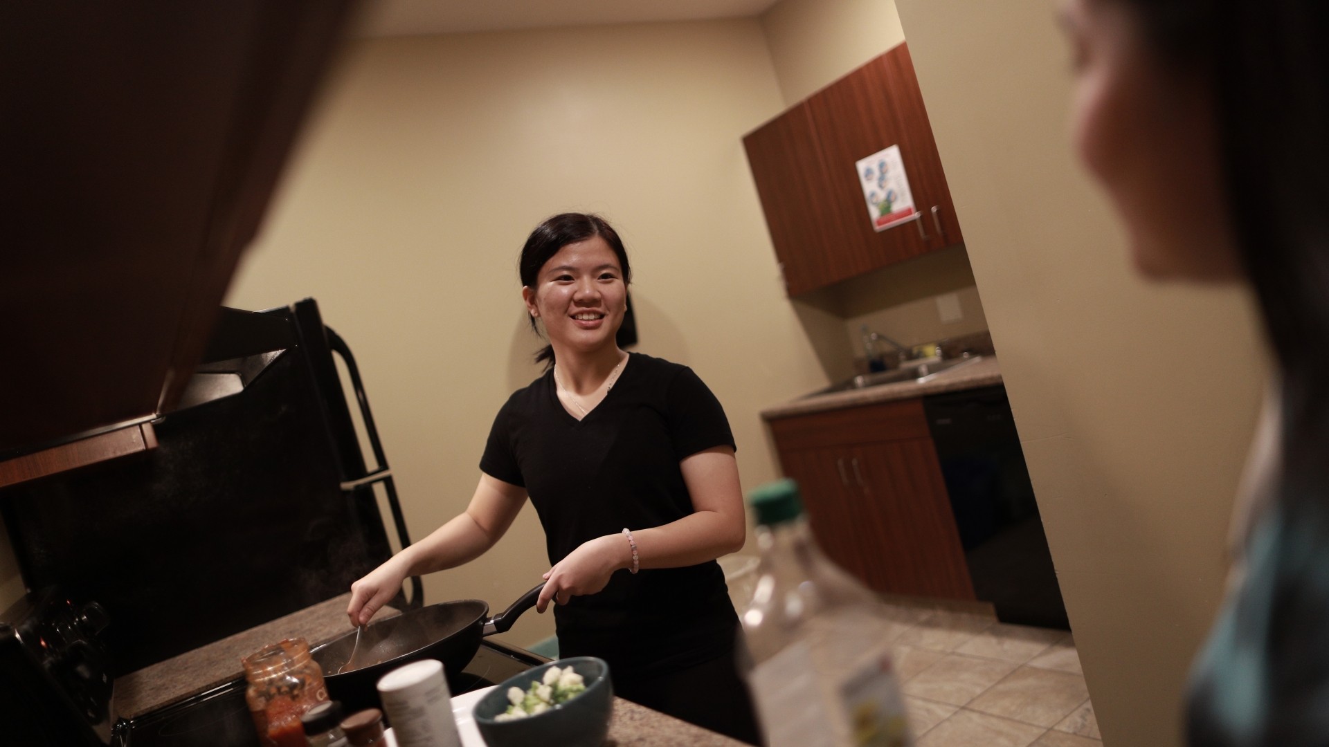 Student cooking in the O'Regan Hall Kitchen.