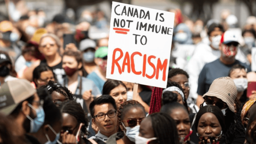People holding sign protesting against racism