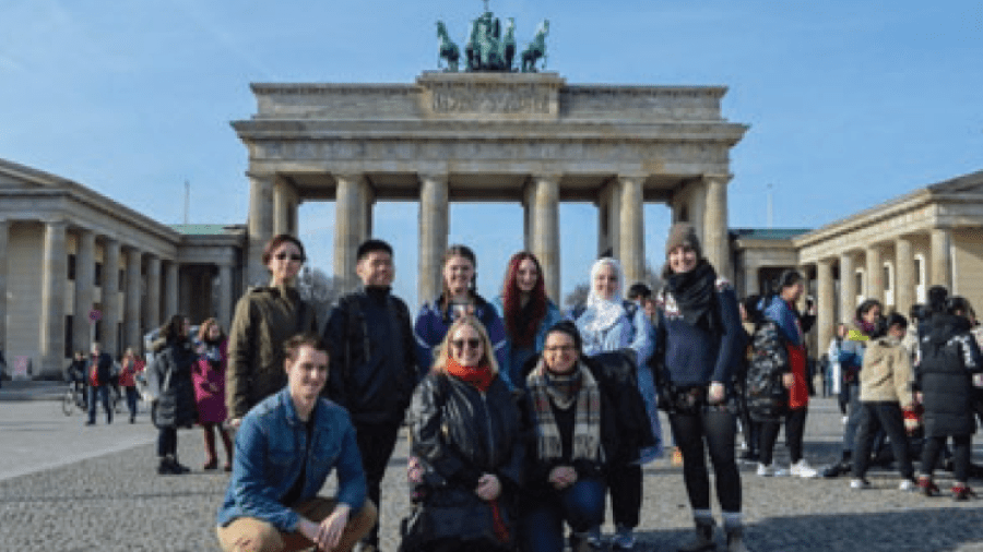 A group of people in front of a pavillion