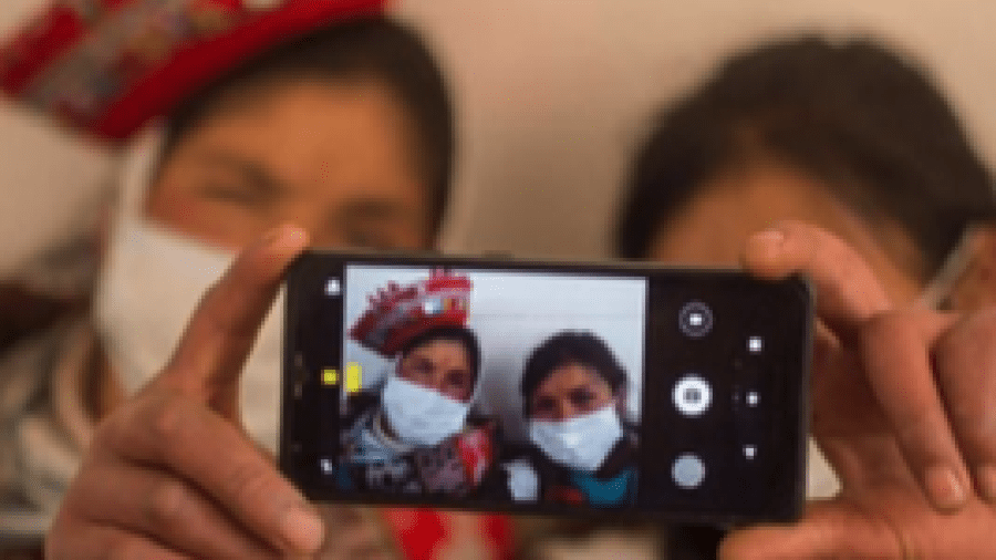 Two people in masks taking a selfie