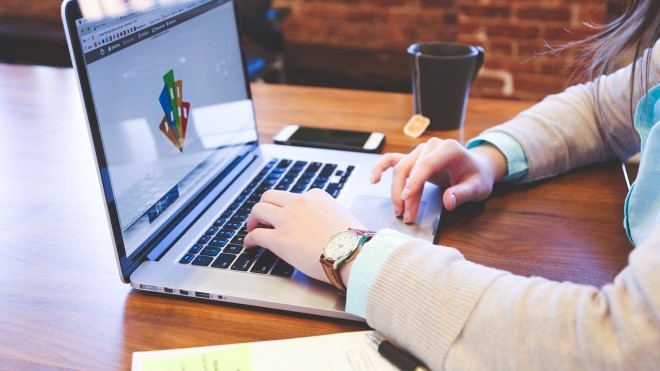 student typing on a laptop