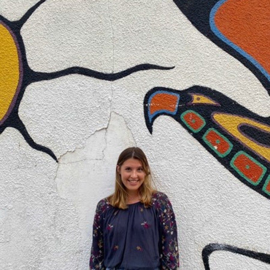 Person standing in front of a mural