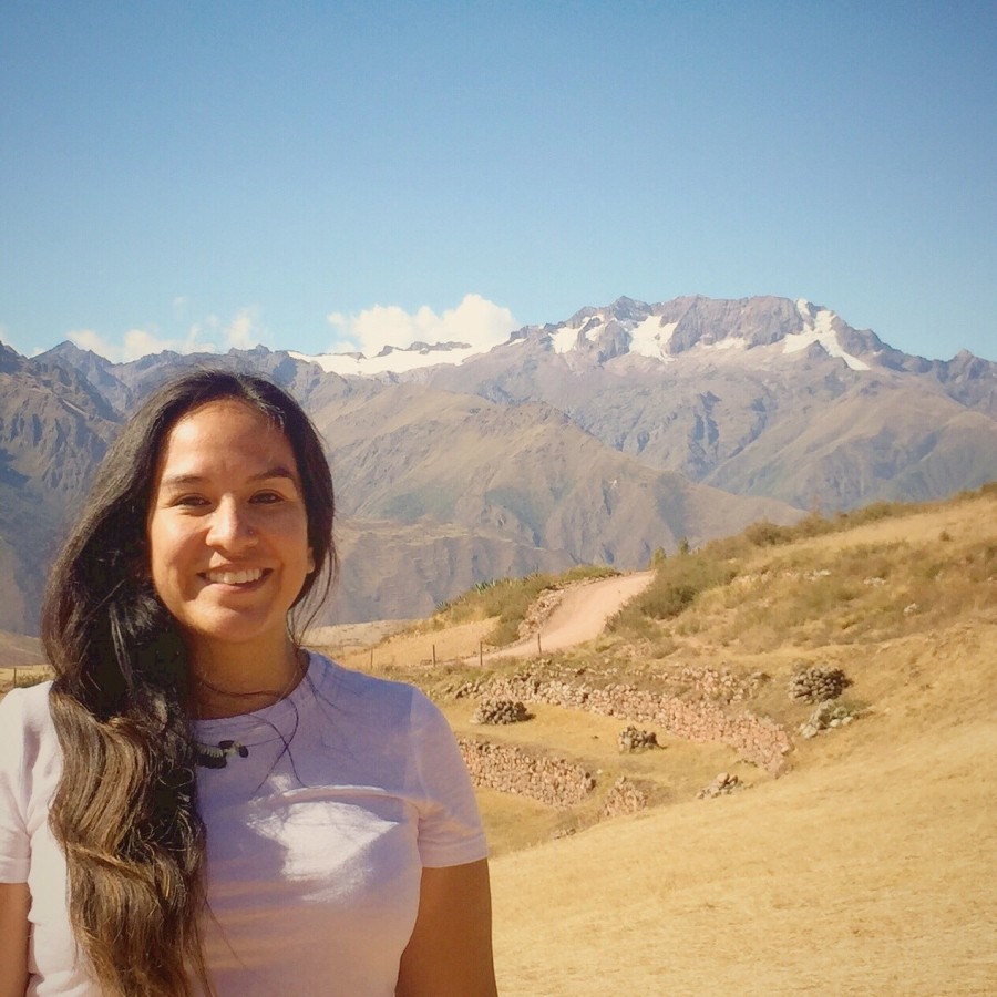 Person smiling standing in front of a desert