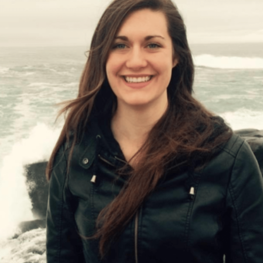 Headshot of woman, with the ocean in the background 