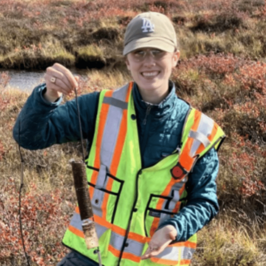 Student outdoors in fishing attire 