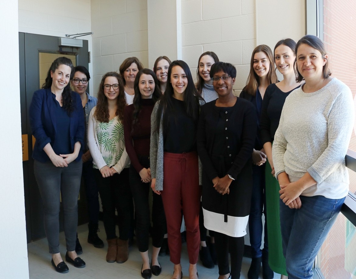 Group of people standing and smiling for photo