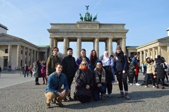 People posing in front of landmark