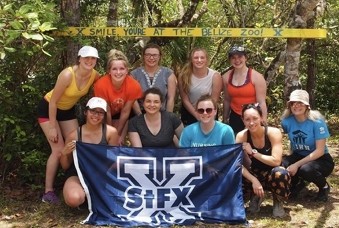 Group pf people posing with StFX flag