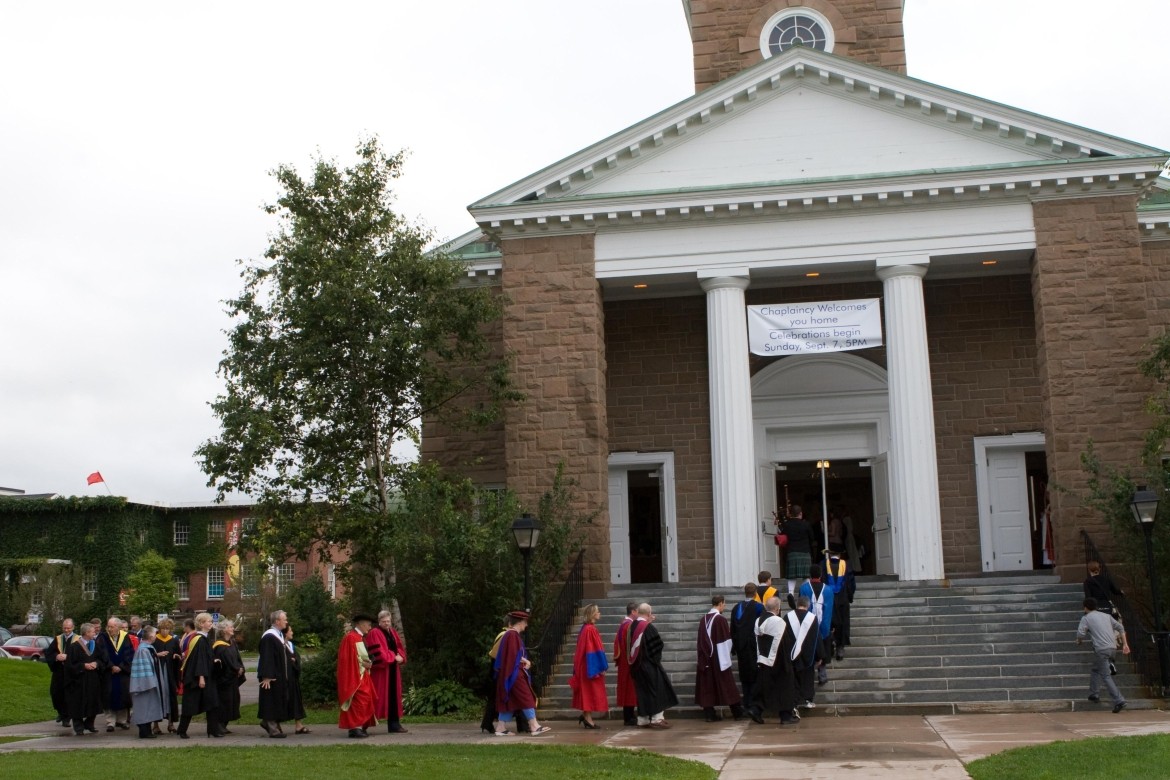 The outside of a chapel with people gathered