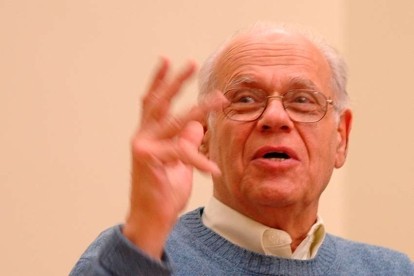Close up of a man speaking with hand gestures.