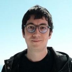 A man wearing glasses and a black jacket