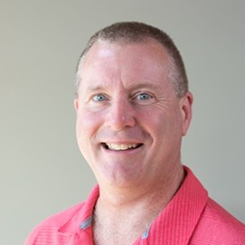 Person wearing pink shirt, smiling