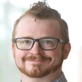 Headshot of man smiling.